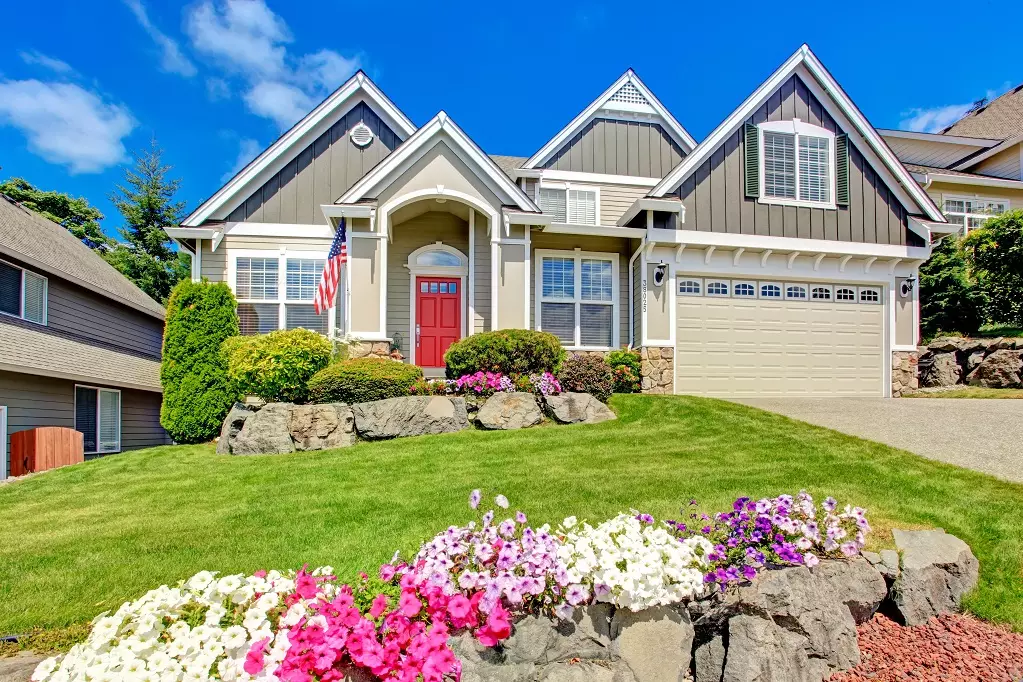 American house with beautiful landscape and vivid flowers